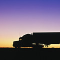 Truck Parked on Freeway at Sunrise by Jeremy Woodhouse