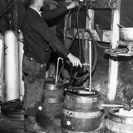 A Brewmeister Fills Kegs At A Bootleg by Everett