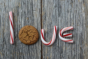 Wall Art - Photograph - Candy Cane And Gingesnap Cookie Spelling The Word Love by Brandon Bourdages