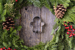 Wall Art - Photograph - Christmas Wreath With Gingerman Cookie In The Middle Of Wood Bac by Brandon Bourdages