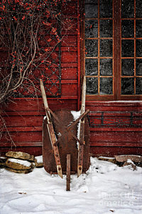 Wall Art - Photograph - Rusty Wheelbarrow Leaning Against Barn In Winter by Sandra Cunningham